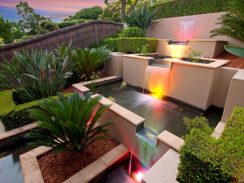 Modern garden design using brick with fish pond & decorative lighting